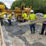 Workers installing concrete