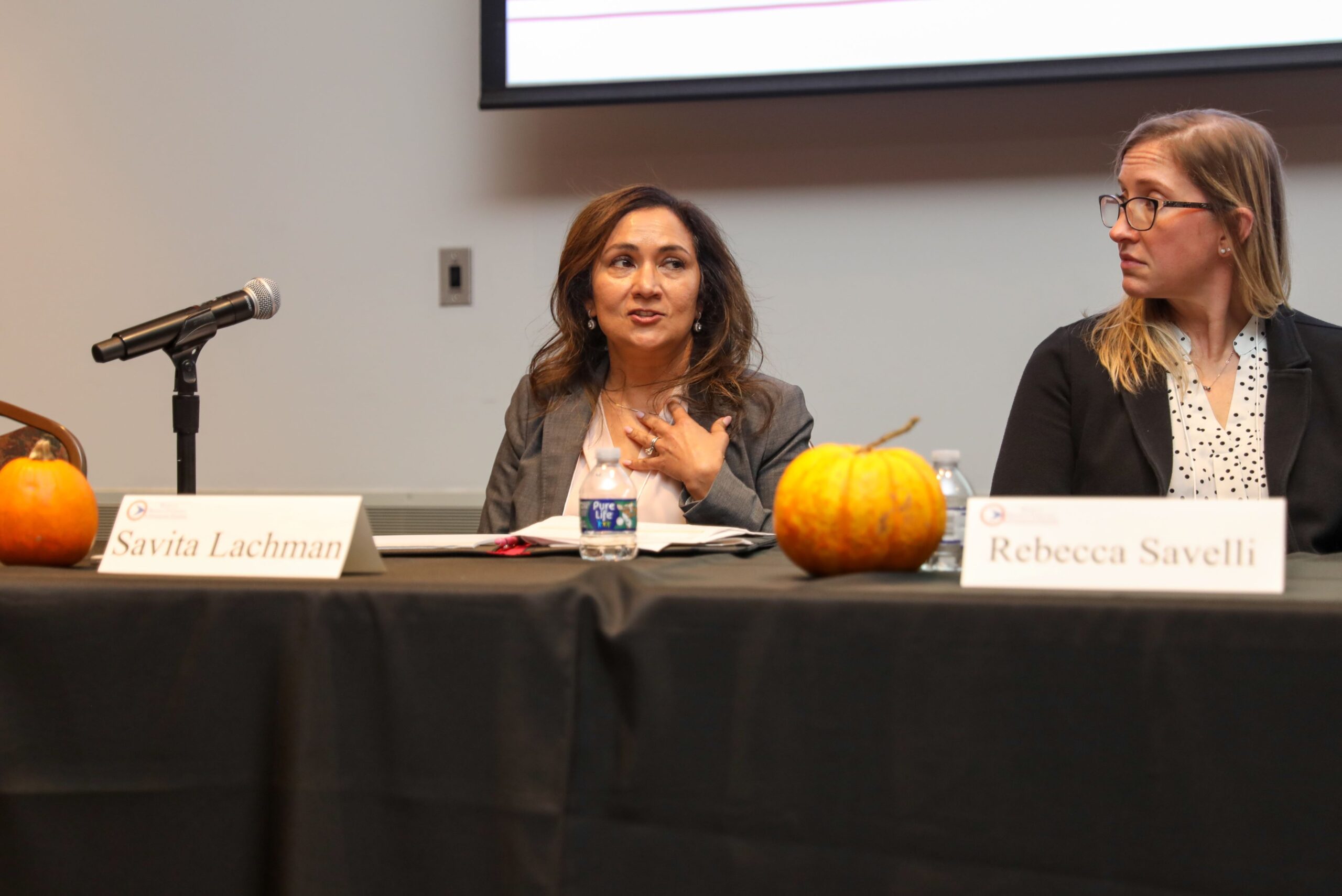 Savita Lachman and Rebecca Savelli sitting on a panel discussion