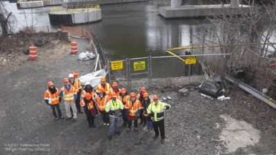 An aerial photo of a group of people wearing construction outfits