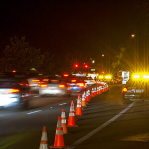 Cones and police car lighting to protect workers during nighttime