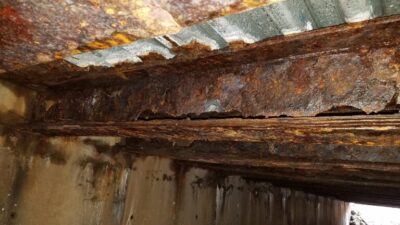Rusted steel beams under a bridge
