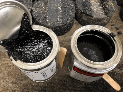 Two containers of modified asphalt binders